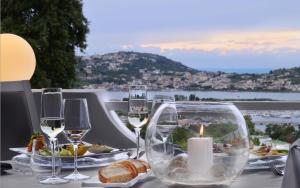 a table with wine glasses and bread and a candle at Hotel Cala Moresca in Bacoli