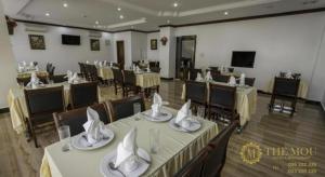 a banquet hall with tables and chairs with napkins at The Mou Hotel in Phnom Penh