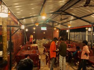 a group of people standing around in a restaurant at Dandeli redstone cottages in Dandeli