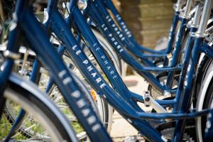 a group of blue bikes parked next to each other at Le Phare in Les Portes