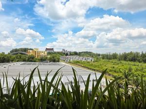 an empty parking lot with buildings in the background at Cozy Home TTDI Adina, Section 13, Shah Alam in Shah Alam