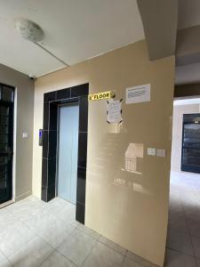 a lobby with a hotel sign on a wall at Gnittel haven in Nairobi
