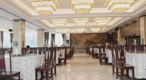 a row of tables and chairs in a banquet hall at Feicheng Blossom Hotel in Feicheng