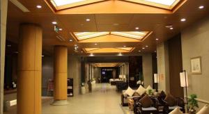 a lobby with couches and chairs in a building at Huangshan Xuanyuan International Hotel in Huangshan +249 photos