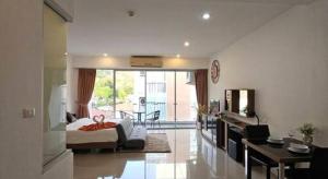 a living room with a bed and a dining room at Chic Residences at Karon Beach in Karon Beach