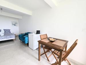 a dining room with a table and chairs in a room at Les locations de Miche in Le Vauclin