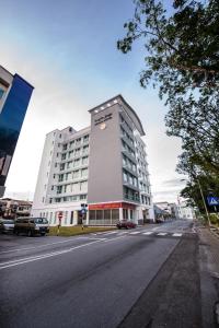 a large white building on a city street at Keoja Hotel in Kuala Belait