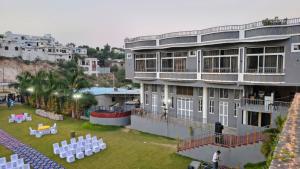 a large building with a lawn in front of it at Shree Vallabh Resort in Nāthdwāra