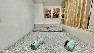 a bed in a room with two pillows on it at Black Lotus III l 24hr Self Check-in l City centre l Free parking in Banská Bystrica