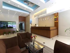 a lobby with couches and a table and a counter at Shijia Inn On the Bund in Shanghai