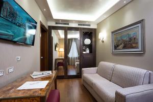a living room with a couch and a table at Hotel Santa Chiara in Venice
