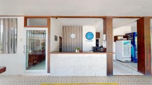 a kitchen with a counter and a refrigerator in a room at Deejai hotel in Ban Hua Laem