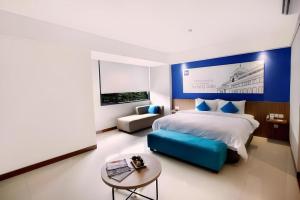 Ένα ή περισσότερα κρεβάτια σε δωμάτιο στο Indies Style Hotel Bandung +210 φωτογραφίες