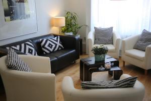 sala de estar con sofá y 2 sillas en B&B Belgravia, en Londres