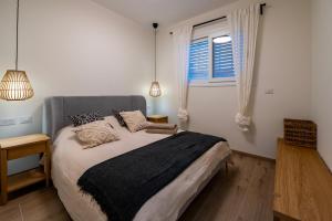 a bedroom with a large bed and a window at Shifon Ein Zivan in Ein Zivan