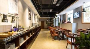 a dining room with tables and chairs in a restaurant at James Joyce Coffetel·Bao Ji Gao Tie Nan Zhan in Baoji