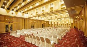 a large banquet hall with white chairs in it at Regency Art Hotel in Macau +228 photos