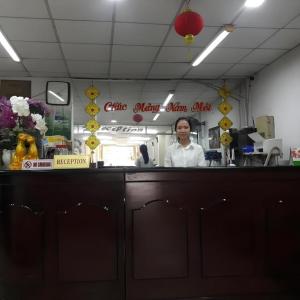 a chef standing behind the counter of a restaurant at Quang Sang Hotel Can Tho in Can Tho