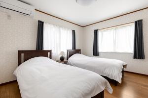 Postel nebo postele na pokoji v ubytování 浅草付近一軒家Emi