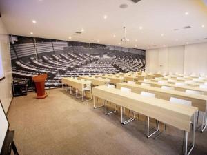 a lecture hall with rows of chairs and a podium at ibis Xi'an First Gaoxin RD in Xi'an