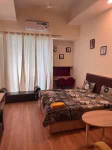 a hotel room with two beds and a table at Singh comfy studio in Ghaziabad