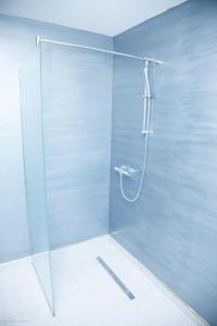 a shower with a glass door in a bathroom at Apartments Konak in Visoko +33 photos