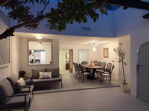 a dining room and living room with a table and chairs at Charming Seaside House in Pag