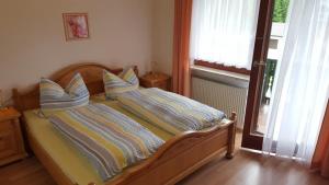 a bedroom with a bed with two pillows on it at Pension Waldblick in Bayerisch Eisenstein