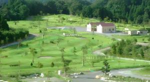 an aerial view of a golf course with a building at Business Hotel BL Kuwana in Kuwana