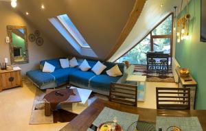 a living room with a blue couch and a table at Kalinderu Slope View in Buşteni