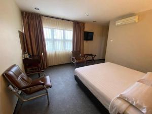Ένα ή περισσότερα κρεβάτια σε δωμάτιο στο ID Hotel Segamat