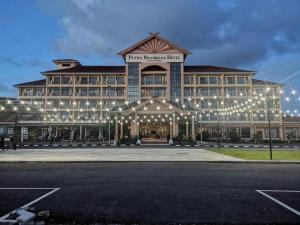 a large building with lights in a parking lot at Putra Brasmana Hotel in Kuala Perlis