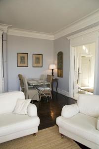 a living room with two white couches and a table at Von Otterska Villan i Gränna in Gränna