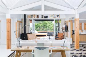 a living room with white furniture and a large window at Ha(a)ïtza in Pyla-sur-Mer