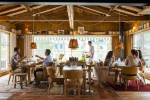 a group of people sitting at tables in a restaurant at Ha(a)ïtza in Pyla-sur-Mer