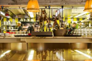a bar with people behind the counter of a restaurant at Ha(a)ïtza in Pyla-sur-Mer