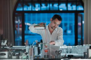 a man in a kitchen preparing a drink at Ha(a)ïtza in Pyla-sur-Mer