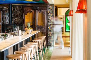 a row of stools at a bar in a restaurant at Ha(a)ïtza in Pyla-sur-Mer