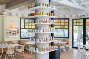 a restaurant with tables and chairs and stained glass windows at Ha(a)ïtza in Pyla-sur-Mer