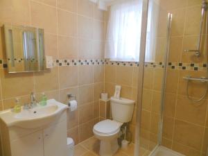 a bathroom with a toilet, sink, and shower at Weymouth Beach B&B - Adult Only in Weymouth