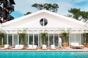a man walks by a pool in front of a house at Ha(a)ïtza in Pyla-sur-Mer