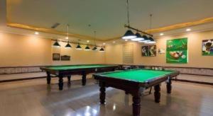 two green ping pong tables in a large room at Osotto Recreation Hotel Baiyun in Guangzhou