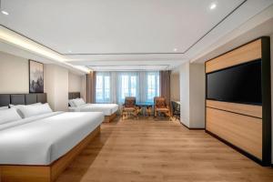 TV a/nebo společenská místnost v ubytování GreenTree Inn Harbin Central Avenue