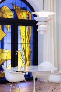 a dining room with a table and a stained glass window at Ha(a)ïtza in Pyla-sur-Mer
