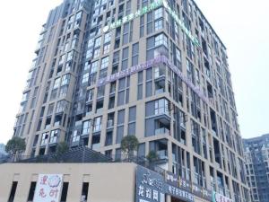 a tall building with writing on the side of it at GreenTree Inn Sichuan Chengdu Airport Road Express Hotel in Chengdu