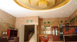 a lobby with a large chandelier on the ceiling at GreenTree Inn LangFang YanJiao Tianyang Plaza Express Hotel in Gaolou