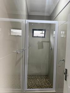 a shower with a glass door in a bathroom at Le Caille, St Lucia Two bedroom unit in St Lucia +14 photos