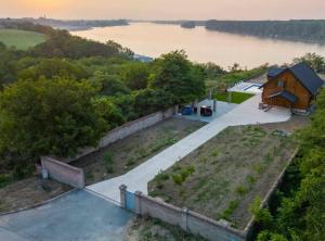 an aerial view of a house next to a lake at Wooden House Vučedol in Vukovar
