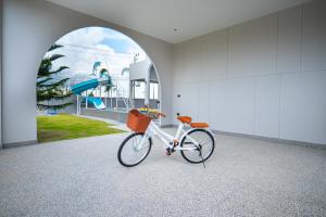 a bike parked in a room with a mural at Triple P พูลวิลล่า ชะอำ in Ban Bo Prakhon