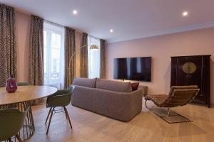 a living room with a couch and a table at Casa Cosí in Luxembourg